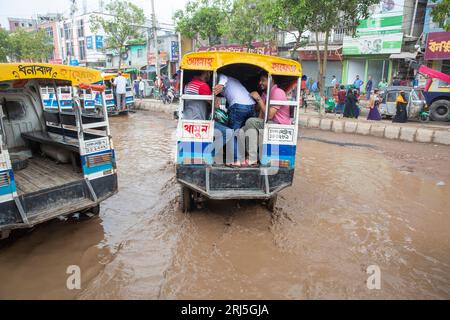 Human howlers on a submerged road at Jurain in Dhaka, Bangladesh. Stock Photo