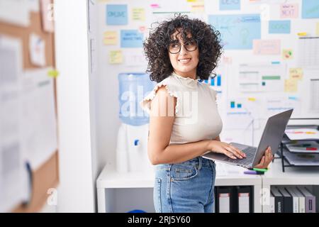 Young middle eastern woman business worker using laptop working at office Stock Photo