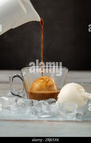 Affogato coffee with vanilla ice cream in a glass cup on wooden table Stock Photo