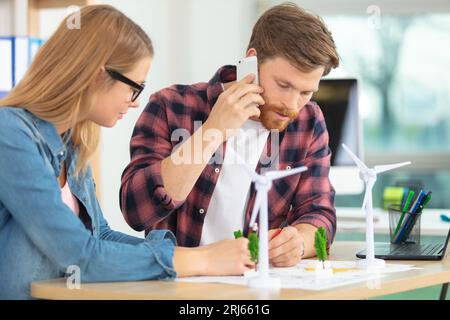 architects sitting around table having meeting Stock Photo