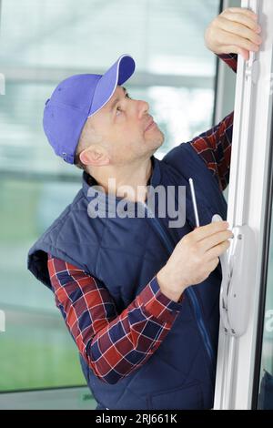 worker with different pvc window Stock Photo