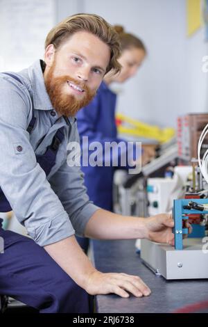 industrial worker assembles electronic components in a factory Stock Photo