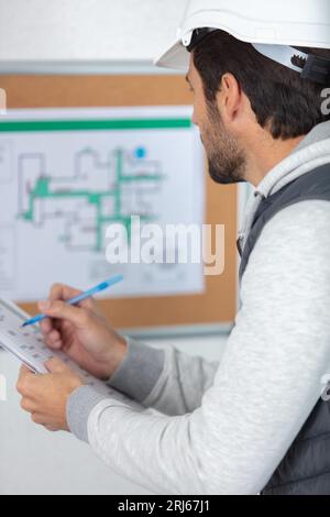 architect checking insulation during house construction Stock Photo