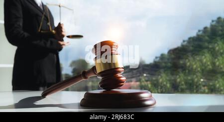 Lawyer's hand concept justice with judge gavel, Businessman in suit or Hiring lawyers in the digital system. legal law, prosecution, legal adviser Stock Photo