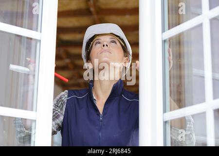 engineer builder woman checking window Stock Photo