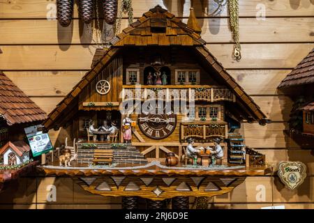 A vintage cuckoo clock on a wooden wall in Triberg im Schwarzwald, Germany. Stock Photo