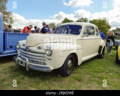 Old white late 1940s Ford V8 Super Deluxe coupe on the lawn. CAACMACH 2023 classic car show Stock Photo