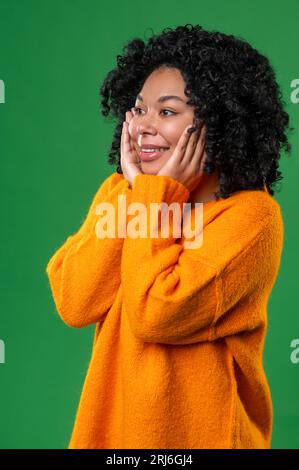 Happy dark-haired ypung woman in orange Stock Photo - Alamy