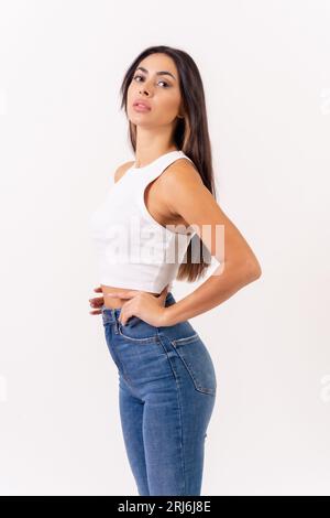 Portrait Of A Beautiful Stylish Young Brunette In Crop Top And Jeans. Stock  Photo, Picture and Royalty Free Image. Image 46512737.