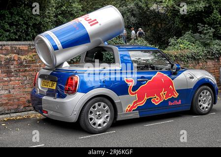 Red Bull car promotion vehicle decaled out in the brands emblem. Modified Mini One Classic car. England, UK Stock Photo