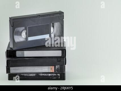 A Vintage VHS video cassettes, a classic recording technology from the 1980s, on a plain backdrop Stock Photo