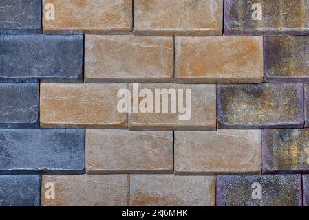 Wall surface with rectangular brick blocks with different colors and stone texture for the exterior. Stock Photo