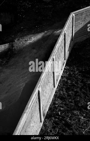 A high-resolution, black and white image of a brick wall with subtle texture and details Stock Photo