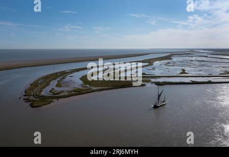 Old Thames Barge Boat moored on river Alde near Orford ness next to salt marshes, Orford, Suffolk, England Stock Photo