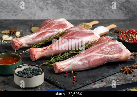 Lamb shank. Raw lamb shank meat on dark background. Butcher products Stock Photo