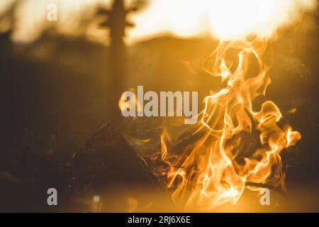 A closeup of a fiery bonfire burning brightly at sunset Stock Photo
