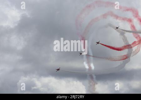 Jet fighters in cloud. Fighter planes in airshow on blue sky. et planes going off formation in the sky. Air force fighter jet plane in full flight. Stock Photo