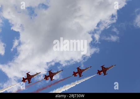 Jet fighters in cloud. Fighter planes in airshow on blue sky. et planes going off formation in the sky. Air force fighter jet plane in full flight. Stock Photo