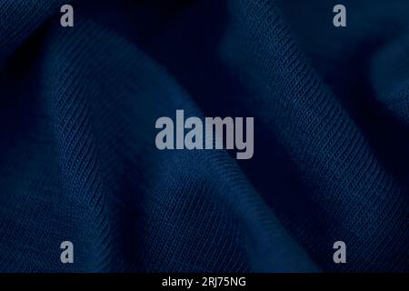A high resolution photograph of a smooth blue silk fabric draped over a white background Stock Photo