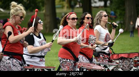 Batala Samba Band in Whitworth Park, Manchester, UK, plus other visitors to the park that afternoon, 19th August, 2023. Stock Photo