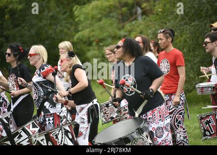 Batala Samba Band in Whitworth Park, Manchester, UK, plus other visitors to the park that afternoon, 19th August, 2023. Stock Photo