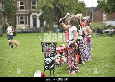 Batala Samba Band in Whitworth Park, Manchester, UK, plus other visitors to the park that afternoon, 19th August, 2023. Stock Photo