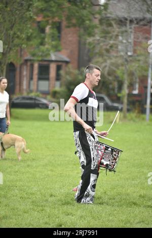 Batala Samba Band in Whitworth Park, Manchester, UK, plus other visitors to the park that afternoon, 19th August, 2023. Stock Photo