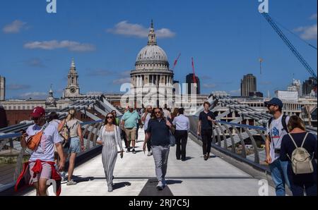 London, UK. 21st August 2023. People walk along Millennium Bridge as sunshine and warm weather return to London after days of wet and cold weather. Credit: Vuk Valcic/Alamy Live News Stock Photo