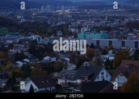 Urdorf village with city lights contrast with evening sky at sunset in pastel colours. Stock Photo