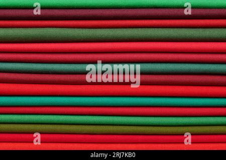 Stack of red and green fabrics as a vibrant background image Stock Photo