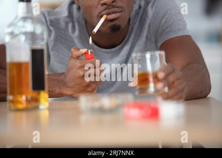 alcohol addicted man at the table Stock Photo