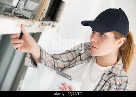 architect woman checking windows on site Stock Photo