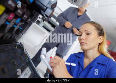 female technician fixing a printer Stock Photo