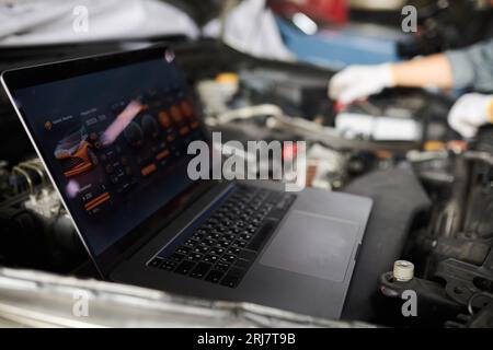Mechanics using program on laptop when analyzing car computer systems and components Stock Photo