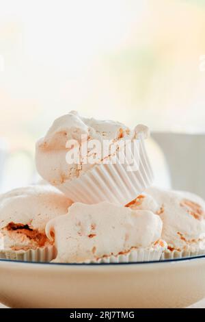 closeup of some merengues almendrados, spanish baked meringues with almonds, in a white ceramic bowl Stock Photo