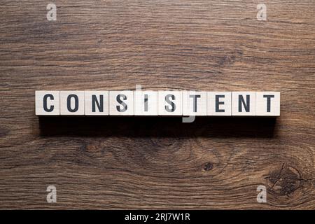Consistent - word concept on building blocks, text Stock Photo