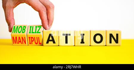 Mobilization or manipulation symbol. Concept words Mobilization Manipulation on wooden cubes. Beautiful white background. Psychologist hand. Psycholog Stock Photo