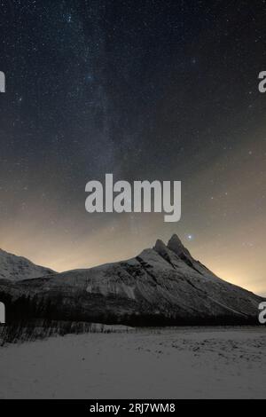 Milky Way above toblerone mountain in Skibotn, Norway Stock Photo