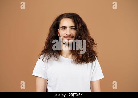 Portrait Of Handsome Latin Guy With Long Curly Hair, Studio Stock Photo