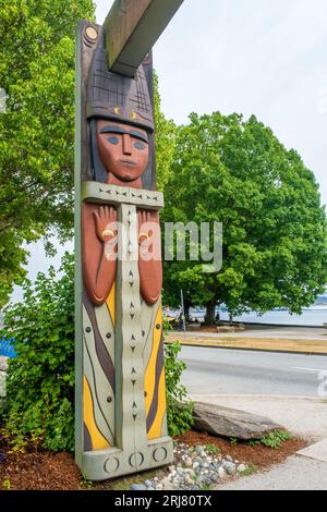 Three red cedar portals are on display at Stanley Park in Vancouver near the First Nations art and totem pole collection at Brockton Point.  Their for Stock Photo