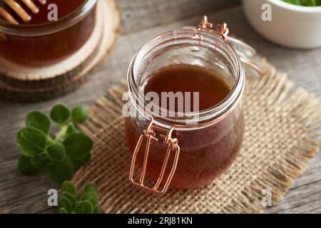 Homemade Plectranthus amboinicus syrup for common cold, on a table Stock Photo