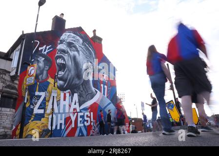 London, UK. 21st Aug, 2023. Fans walk past a mural of former Crystal Palace player Wilfried Zaha before the Premier League match at Selhurst Park, London. Picture credit should read: Paul Terry/Sportimage Credit: Sportimage Ltd/Alamy Live News Stock Photo