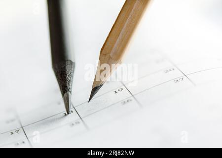Close Up of dark and light pencils on white paper of calendar. Concept of The National Day of Knowledge, Planning for business meeting or education Stock Photo
