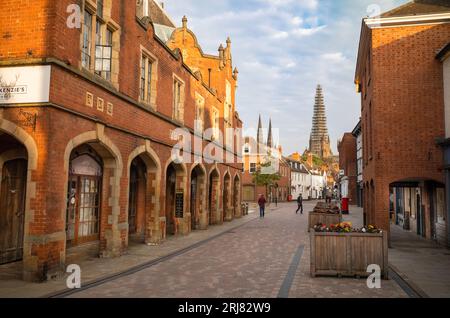 A view at sunrise of Lichfield Cathedral, with its main spire being restored, from Conduit Street in the centre of this ancient and historic city in S Stock Photo