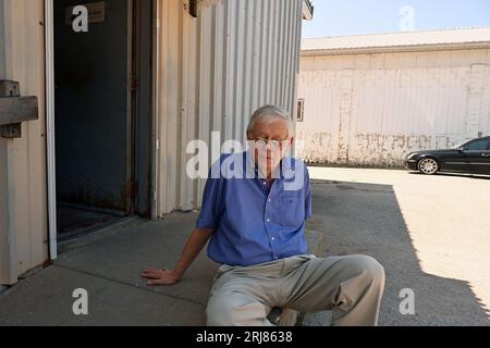 MARION, KANSAS - AUGUST 21, 2023 Eric Meyer publisher of the Marion County Record newspaper takes a break from on camera and telephone interviews at the back door of the newspaper Stock Photo