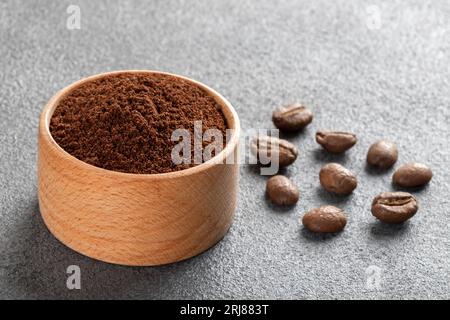 Coffee beans with a bowl of ground coffee Stock Photo