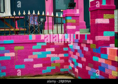 Multi-coloured brick wall infront of Blackpool Hotel Stock Photo