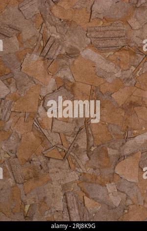 Rough old textured craft cardboard vertical background handmade from torn pieces for design Stock Photo