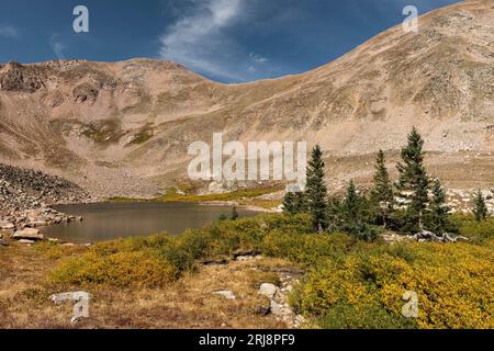 Autumn colors surround Ruby Jewel Lake which is located in the Rawah Mountain Range. Ruby Jewel Lake is a destination to a beautiful landscape. Stock Photo
