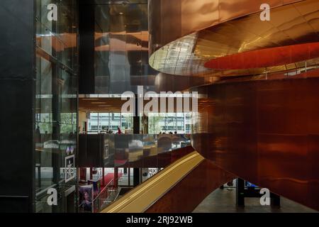 Interior view at the atrium with iconic curvature copper staircase at Experimentarium, Science Museum, in Copenhagen, Denmark. Stock Photo